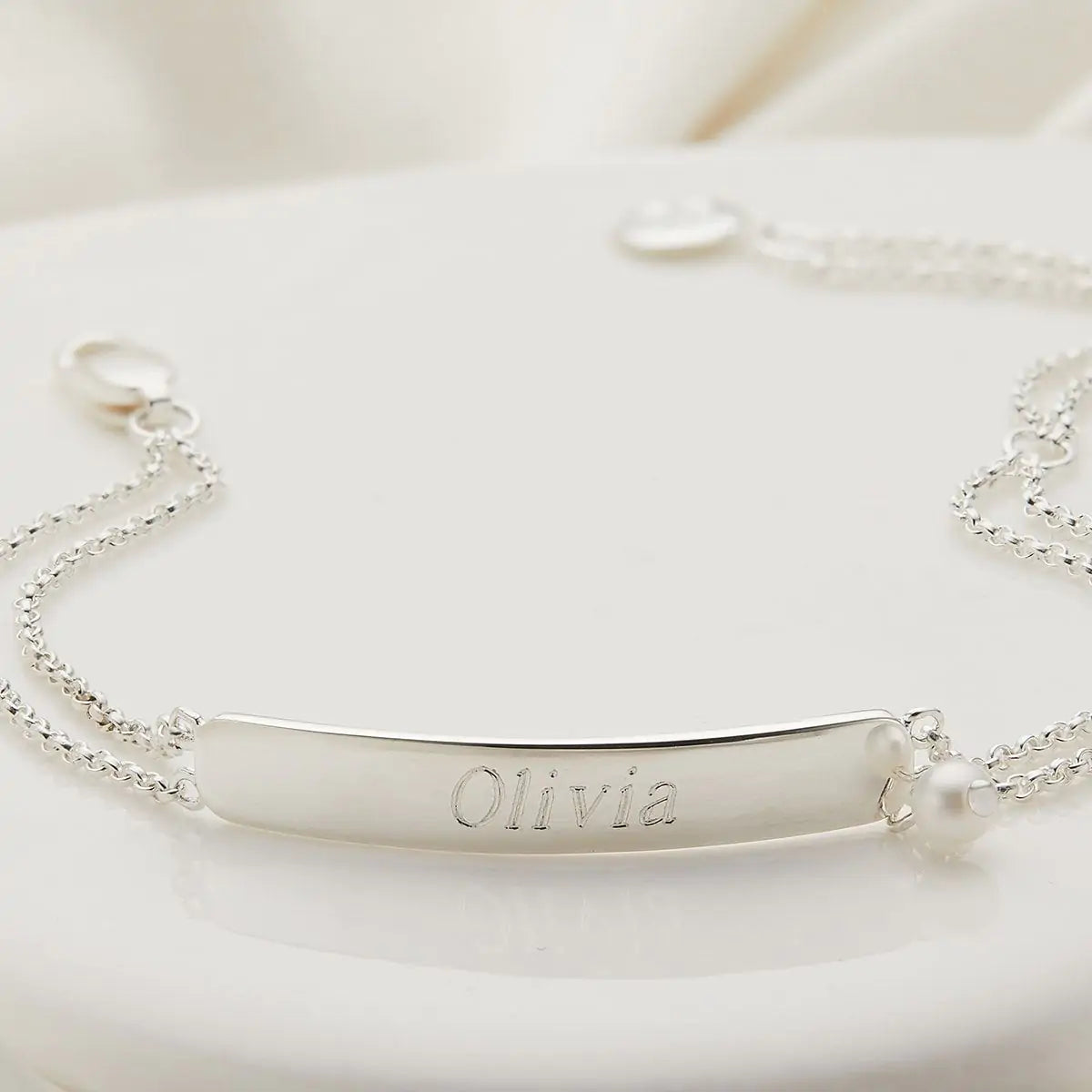 Silver bracelet with 'Olivia' engraving on a white background